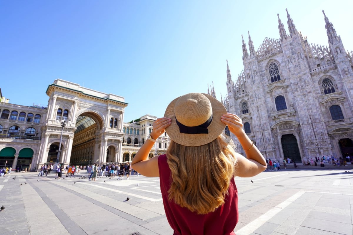 woman holding her hat in Milan, Italy