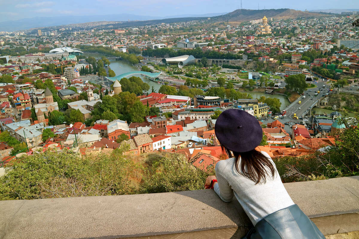 Young Female Tourist Admiring A View Of Narikala Fortress In Tbilisi, Georgia