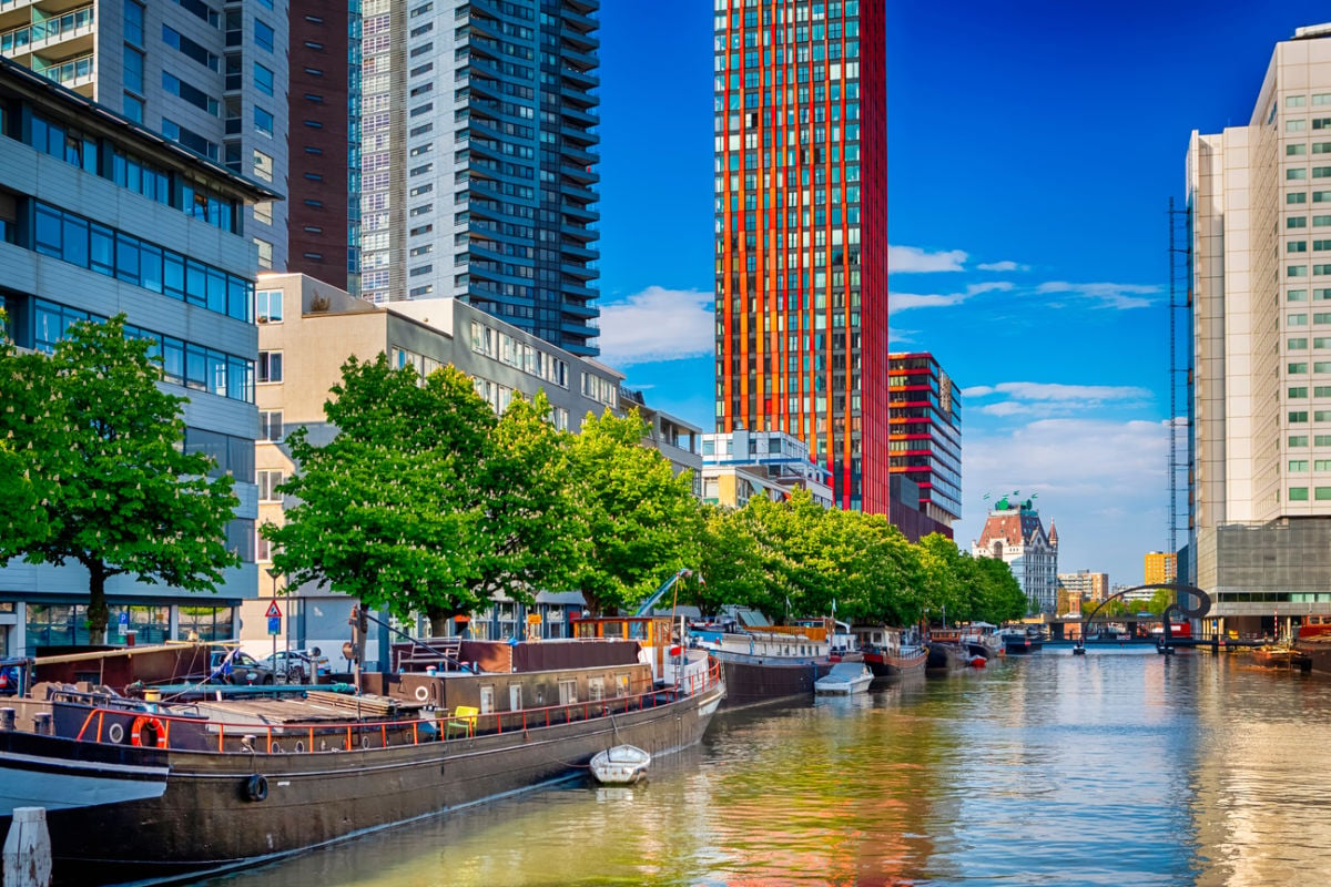 Flowing canal below vibrant skyscrapers in Rotterdam